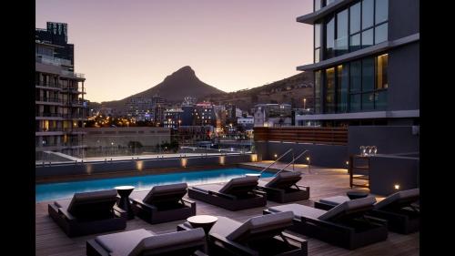 a swimming pool with lounge chairs on a building at Western Cape South Africa in Cape Town