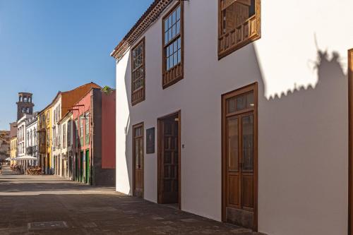 an empty street in a town with wooden doors at La Casa de La Camelia in La Laguna