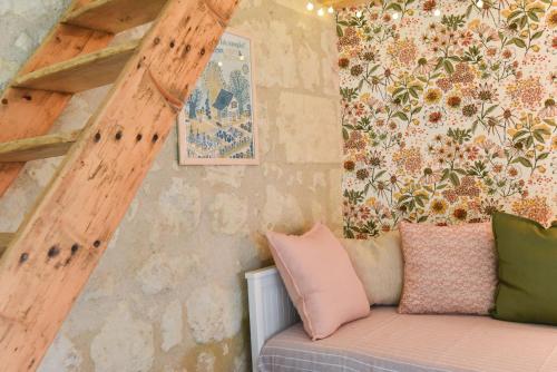 a room with a couch with pillows on it at Cabane Tourangelle - La petite Bohème in Rigny-Ussé