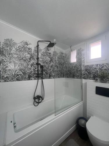 a bathroom with a shower and a bath tub at Beverly house in Kriopigi