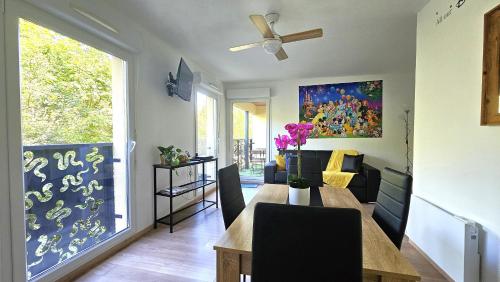 - une salle à manger et un salon avec une table à manger dans l'établissement Magic Dreams Appartement Paris, à Montévrain