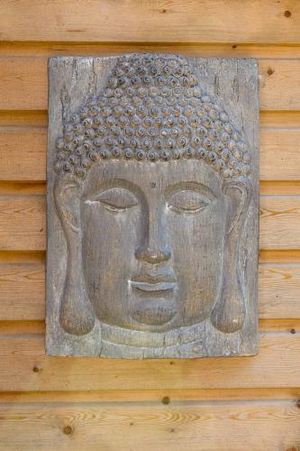 a stone statue of a head on a wall at Hillview Hideaway in Angmering