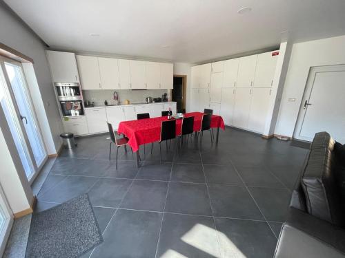 a kitchen with a table and chairs in a room at LMB Alojamento local in Penacova