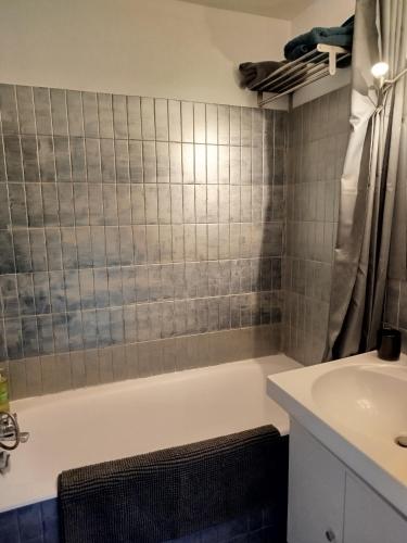 a bathroom with a bath tub and a sink at Île du Frioul in Marseille