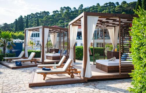 a group of gazebos with chaise lounges at TUI BLUE Kalamota Island - Adults Only in Dubrovnik