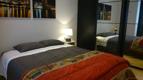 a bedroom with two beds and a lamp in it at Alex Home in Lisbon