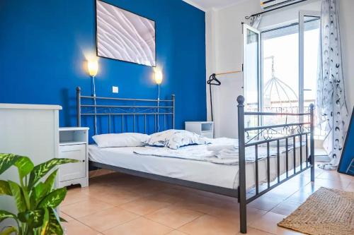 a bedroom with blue walls and a bunk bed at Nowhere Stay in Pefkohori