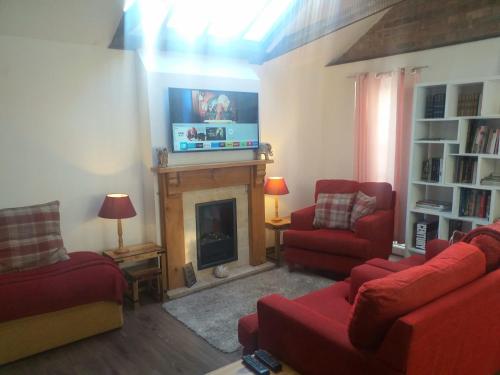 a living room with a fireplace and a tv at House - Sleeps 2 pet friendly & free parking in Hull