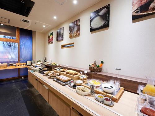 a buffet line with many different types of food at Daiwa Roynet Hotel Tsukuba in Tsukuba