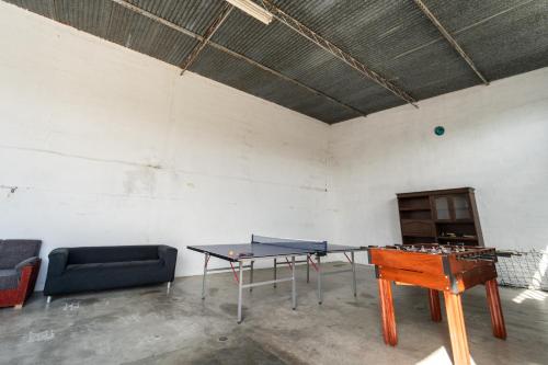 a room with a ping pong table and a couch at Quinta do lagar in Chamusca