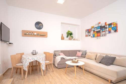 a living room with a couch and a table at Villa Rajski Dvor in Bol