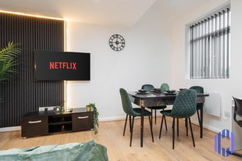 a meeting room with a table and chairs and a tv at Sophisticated & Stylish Flat near Manchester Airport - Sleeps 9 in Manchester