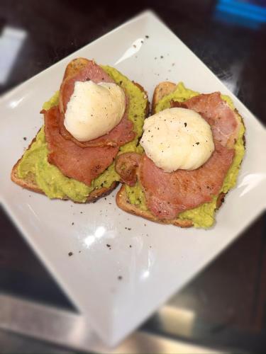 a white plate with two eggs on top of toast at The Six Bells in Rochester