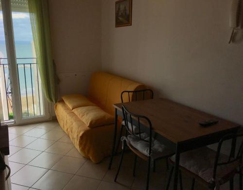 a living room with a couch and a table at Residence Meeting in Gabicce Mare