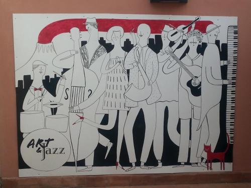 a painting of a group of musicians on a wall at Art & Jazz Hotel in Catania