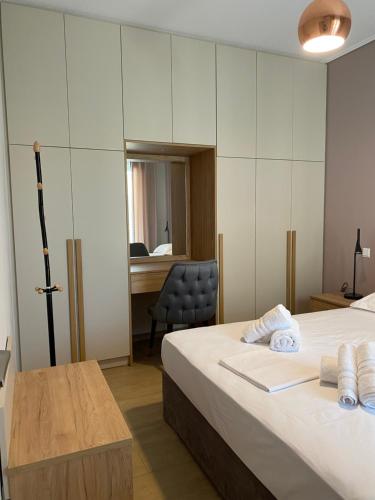 a room with two beds and a desk and a chair at Olia Residences Lesvos in Mytilini