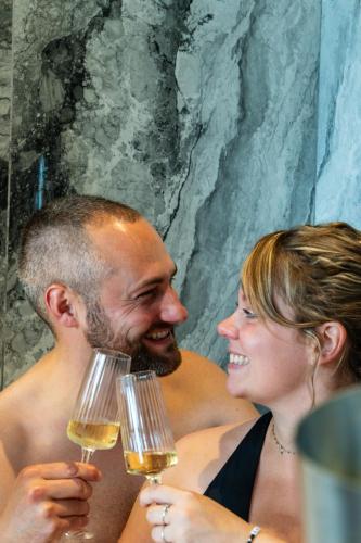 a man and woman holding glasses of wine at L’Impasse in Nampty