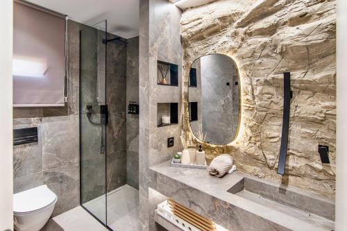 a bathroom with a shower and a toilet and a mirror at Villa Steana in Makri