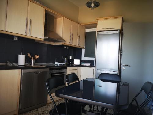 a small kitchen with a table and chairs in it at Sea View Apartment with 3 Bedrooms in Amfilochia in Amfilochía