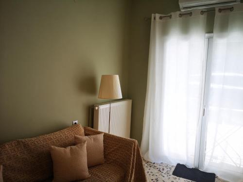 a living room with a couch and a window at Sea View Apartment with 3 Bedrooms in Amfilochia in Amfilochía