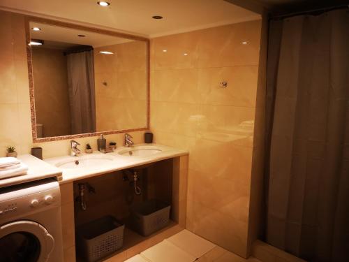 a bathroom with a sink and a shower at Sea View Apartment with 3 Bedrooms in Amfilochia in Amfilochía