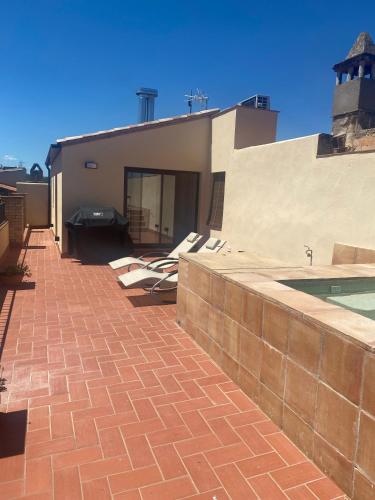 a brick walkway next to a building with a pool at Cal Sabater, Empordà-Costa Brava in Báscara