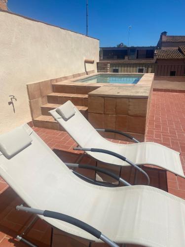 a group of chairs sitting on top of a building at Cal Sabater, Empordà-Costa Brava in Báscara