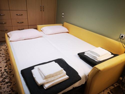 a bedroom with a bed with towels on it at Sea View Apartment with 3 Bedrooms in Amfilochia in Amfilochía