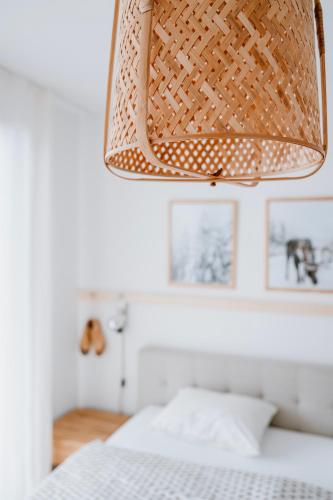 a lamp hanging over a bed in a bedroom at Am Heimberg Skilift - Mullers x Kandahar Suite in Parpan