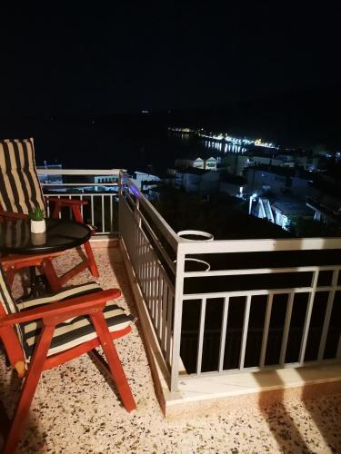 a deck with a chair and a table with a view at Sea View Apartment with 3 Bedrooms in Amfilochia in Amfilochía