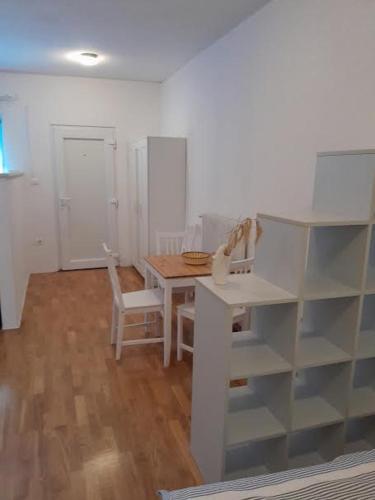a dining room with a table and a table and chairs at apartma pika 2 in Nova Gorica