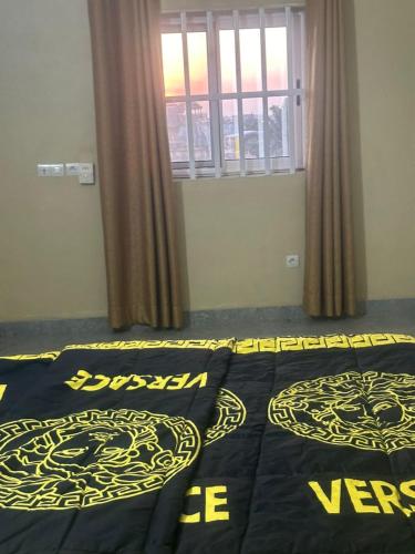 a bedroom with two beds and a window at Avina lux homes Spacious one bedroom in Lomé