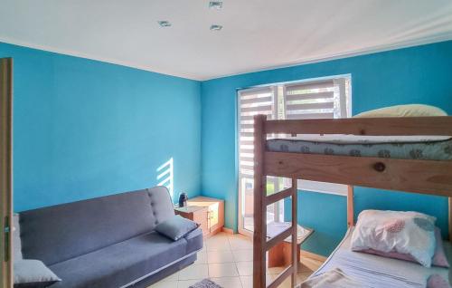 a bedroom with a bunk bed and a couch at 2 Bedroom Cozy Home In Rekowo in Rekowo