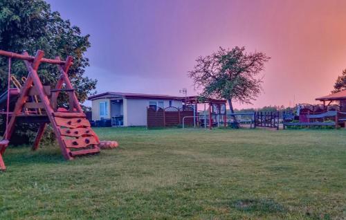 a group of playground equipment in a field at 1 Bedroom Pet Friendly Home In Rekowo in Rekowo