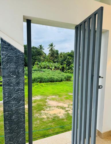 an open door with a view of a green field at Diamond Villa Near Rajagiri Hospital in Alwaye