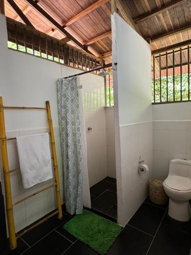 a bathroom with a shower and a toilet at Madre Selva Eco Lodge in Nuquí