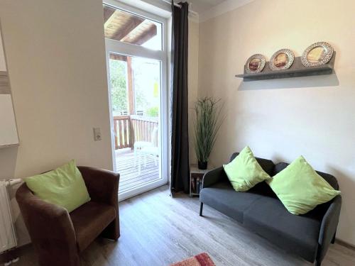 a living room with a couch and chairs and a window at Ferienwohnungen LpP Bad Suderode in Bad Suderode