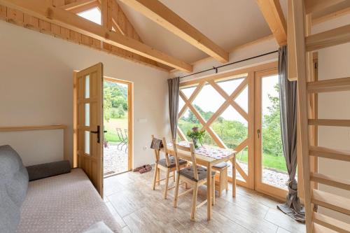 a room with a table and a bed and a window at Pr' Končovc in Kranj