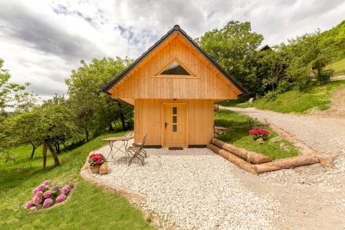 a small wooden house with a gravel driveway at Pr' Končovc in Kranj