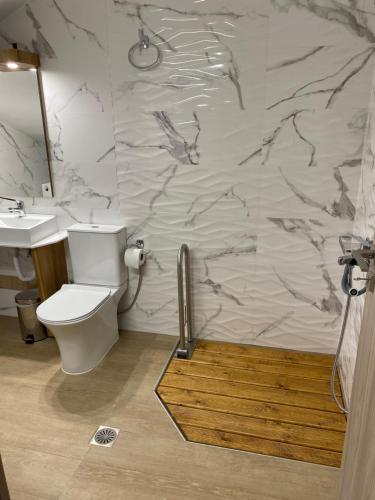 a bathroom with a toilet and a sink at Olia Residences Lesvos in Mytilini