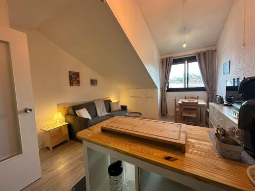 a kitchen and a living room with a table at Le petit Marou in Saint-Lary-Soulan