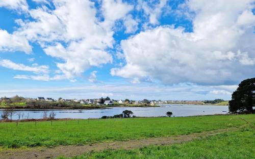 a view of a river under a cloudy sky at L'agapanthe in Belz
