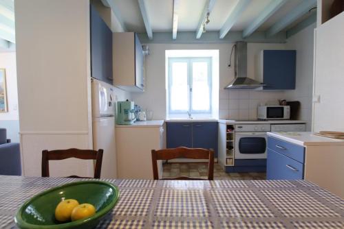 a kitchen with a table with a bowl of fruit on it at Chez requenna in Borce