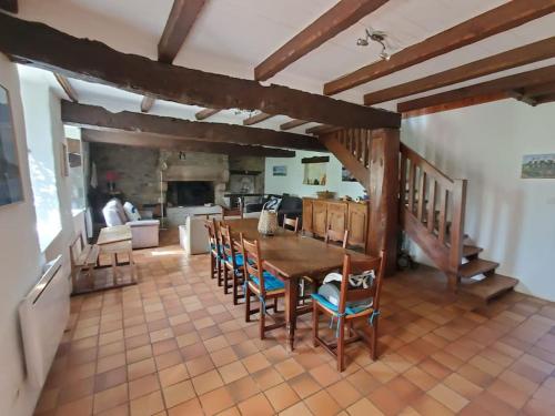 a kitchen and dining room with a table and chairs at Grande maison de famille - Le Petit Pontébart in Paimpol