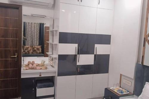 a bathroom with a black and white wall at The Great Escape - Rustic Countryside Stay in Amritsar