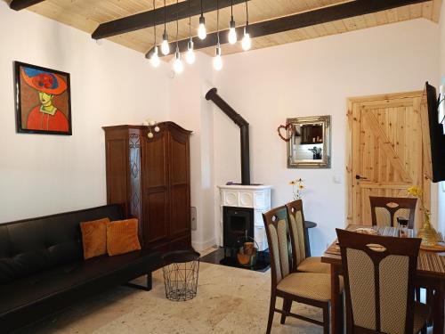 a living room with a couch and a fireplace at Siedlisko Panorama na Koncu Swiata - Całoroczny domek in Podgórz