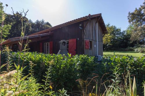 an old barn with a scarecrow standing in front of it at Gite de pernaout in Bélis
