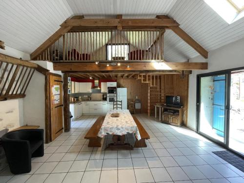 a large room with a table and a kitchen at Grand aoulet in Accous