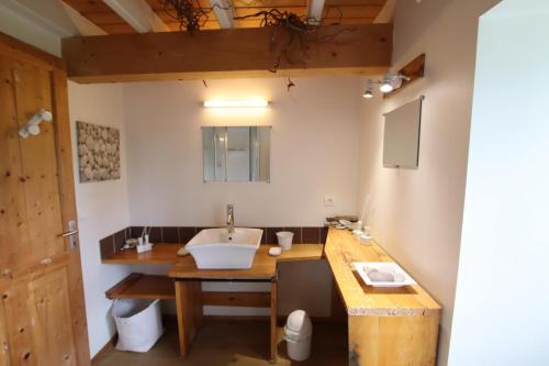 a bathroom with a sink and a wooden counter at Bonnevigne in Lys