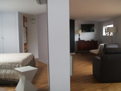 a room with a bed and a couch and a chair at B&B Milu' in Crotone